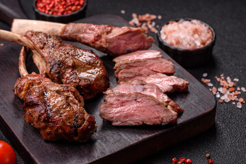 Juicy meat on the bone or rack of lamb. Grilled veal with salt, spices and herbs