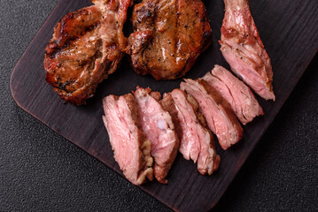 Juicy meat on the bone or rack of lamb. Grilled veal with salt, spices and herbs