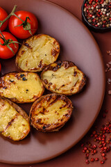Food, potatoes cut in halves or slices grilled. Cooked baked potatoes