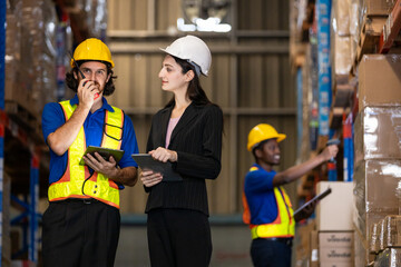 Female manager and male worker checking on shelf with digital tablet in warehouse. Professional workers management business delivery import - export online stock for logistics.