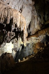 Inside of beautiful old dark cave with many stalactites. Grotte di Is Zuddas, Italy, Sardinia