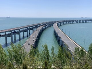 Three bridges merging over blue sea