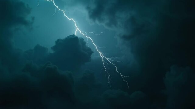 Dark stormy sky with lightning illuminating the clouds at night  
