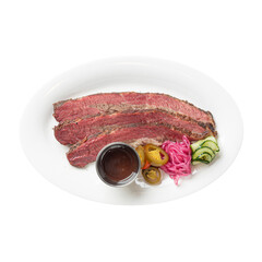 Sliced beef brisket with pickles and sauce