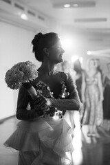 bride in a white dress throws a wedding bouquet