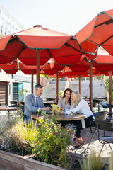 Business team discussing a contract at an outdoor cafe