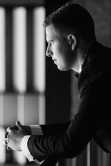 portrait of groom in blue tuxedo in hotel