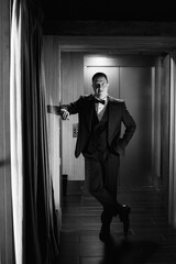 portrait of groom in blue tuxedo in hotel