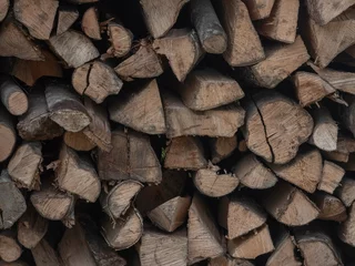 Fotobehang Brandhout Neatly stacked firewood, perfect for a cozy evening by the fireplace, ready to be burned.  © Krasimir