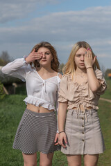 Portrait of two beautiful young girls friends in an urban environment.