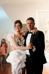the first dance of the bride and groom inside a restaurant