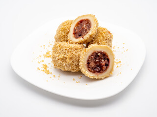 traditional sweet steamed dumplings with a plum jam on white plate