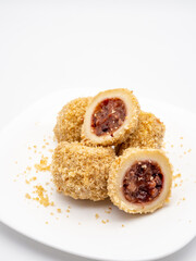 traditional sweet steamed dumplings with a plum jam on white plate