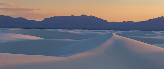 The incredible white sand dunes of White Sands National Park in New Mexico glowing in soft light at sunset. © Nick Monitello