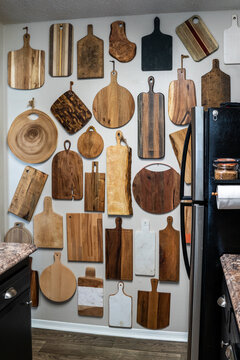 Kitchen with a wall covered in cutting boards 