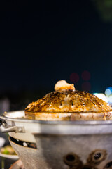 View of dirty pan after eating Thai meat grilled at night.