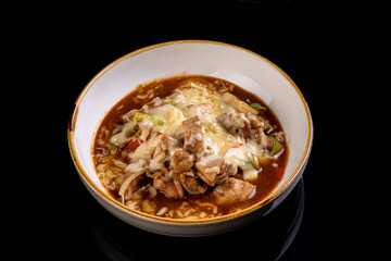 An inviting dish showcases tender pieces of meat sautéed with fresh cabbage and colorful vegetables, all nestled in a rich, savory sauce. It promises warmth and flavor in every bite