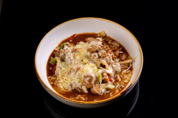 Warm and savory bowl features tender chicken pieces combined with creamy cheese, colorful vegetables, and flavorful rice, creating a delightful comfort dish