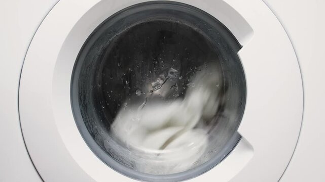 Close-up of a washing machine drum. The concept of using modern technology and cleaning services to simplify household chores and maintain order.