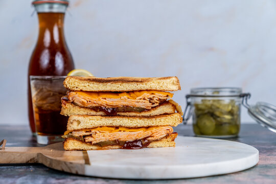 BBQ chicken sandwich with pickles and iced tea