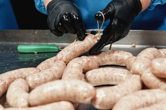 Close up of sausages production process at the meat factory.