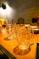 Empty Glass Mugs on Wooden Bar Counter