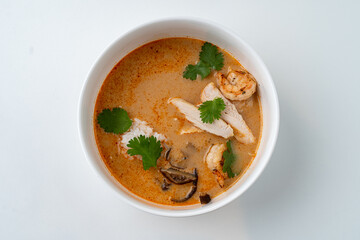 Delight in a delectable bowl brimming with silky broth, succulent shrimp, tender chicken, and fresh herbs, all harmonizing in enticing aromas and textures