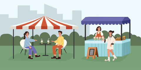 People talking at the outdoor cafe. People enjoying food and drinks at a street food market. Food fair in the city. 