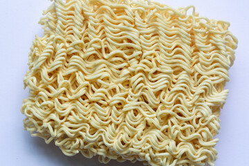Closed up of uncooked, dry, or raw instant noodles. Isolated on white background.