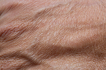 Fototapeta premium Close-up macro of human hand skin texture,The skin texture of Asian men's feet is tan or brown. Men's feet skin background