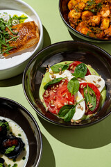 Colorful bowls filled with fresh ingredients showcase a delightful array of gourmet dishes,...