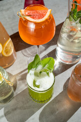 An array of vibrant cocktails showcases a fusion of colors and flavors. Glasses filled with...
