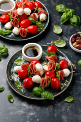 Mini skewer appetizers with salami, mozzarella and tomatoes. Healthy antipasto skewer.