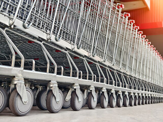 A row of shopping carts is neatly lined up in a straight row
