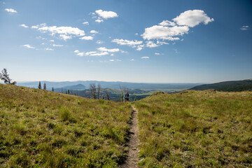 Hiker Emerges Over Hill Along Trail To Electric Peak