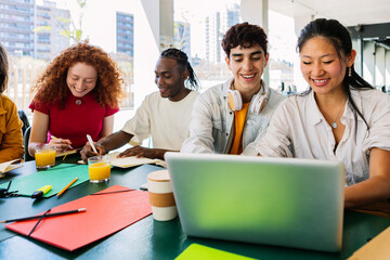 High school teenage students studying together on laptop at campus. Education lifestyle concept