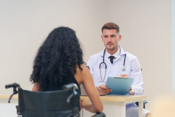 doctor in white gown with stethoscope,asking a woman disabled person on wheelchair for present...