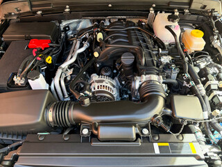 Car engine top view. Open car hood showing detailed auto components. A Modern new car close-up of...