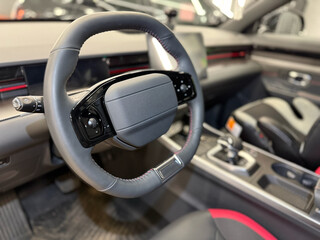 Dark car interior - steering wheel, shift lever and dashboard. Car modern SUV inside. Car Interior...