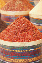 Colorful spices displayed in market stalls of Marrakech