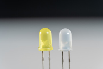 ellow and white LED parts in scientific experimental setup as macro shot on white and black...