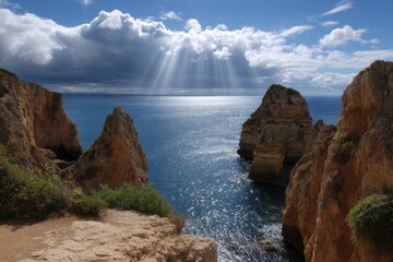 Cliffs frame ocean view with sun rays shining through clouds