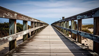 Fototapeta premium Endless Summer A Deserted Boardwalk Stretching to the Horizon Under a Vivid Blue Sky
