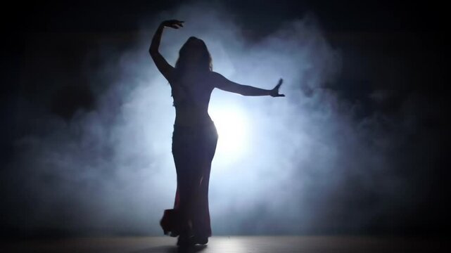 Belly dancer silhouette smoke stage performance