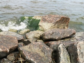 Rocks by the shore with waves splashing