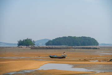 Low Tide Mudflat: Old Fishing Boat, Small Puddles, and Islands