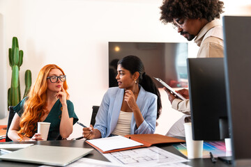 Multiethnic small group of businesspeople meeting in a coworking company office