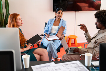 Multiethnic small group of businesspeople meeting in a coworking company office