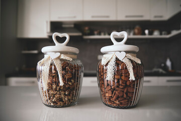 Stylish glass jars with heart shaped lids and lace ribbons hold walnuts and almonds. Perfect for...