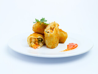 Crispy vegetable risol cut open on a white plate, served with chili sauce. isolated on white background